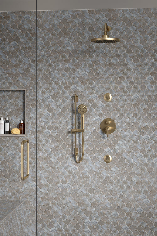 An image of tan mosaic tile installed on a shower wall.